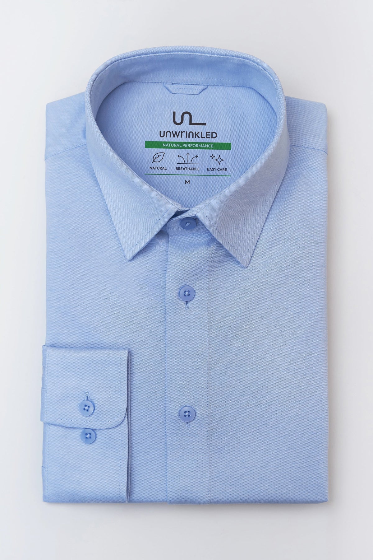 Folded UNWRINKLED Soft Sky Blue men's light blue cotton shirt with collar and cuff visible